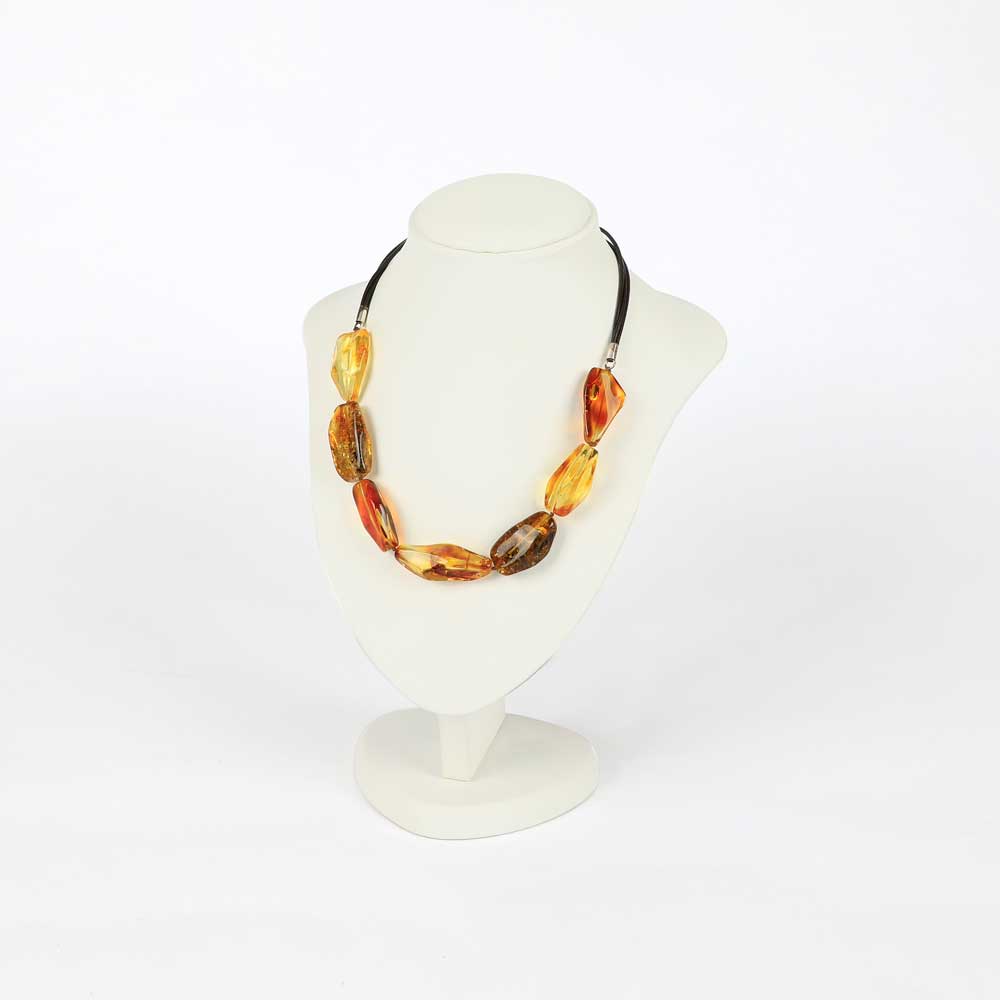 7 pieces amber necklace on white mannequin stand