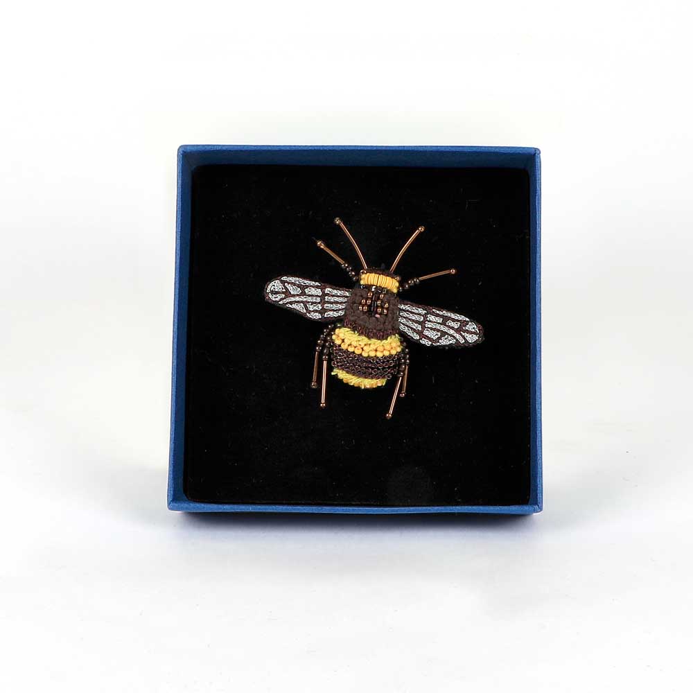 Trovelore Beaded nature brooch hand made in india on white background. Bumble bee