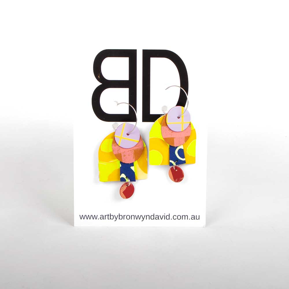 Bronwyn David handmade hand painted leather earrings with surgical steel hoops on white background