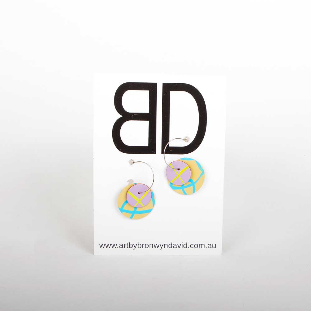 Bronwyn David handmade hand painted leather earrings with surgical steel hoops on white background