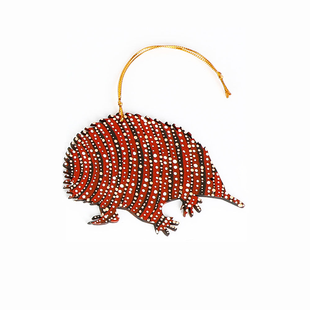 Decorative echidna ornament handpainted by Warlukurlangu Artists, on a white background