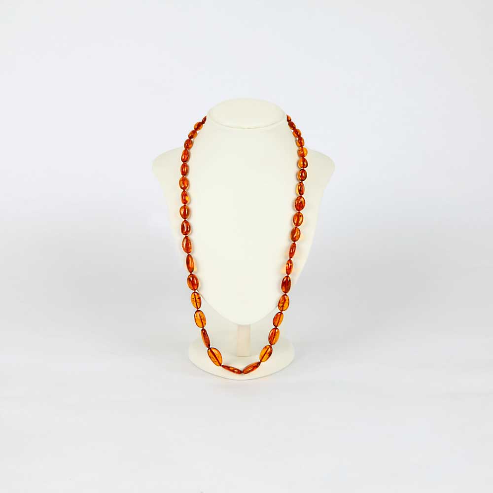 Cognac olive bead amber necklace on white mannequin