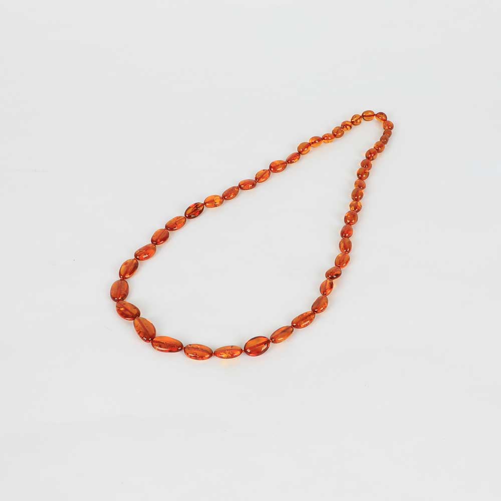 Cognac olive bead amber necklace on white background