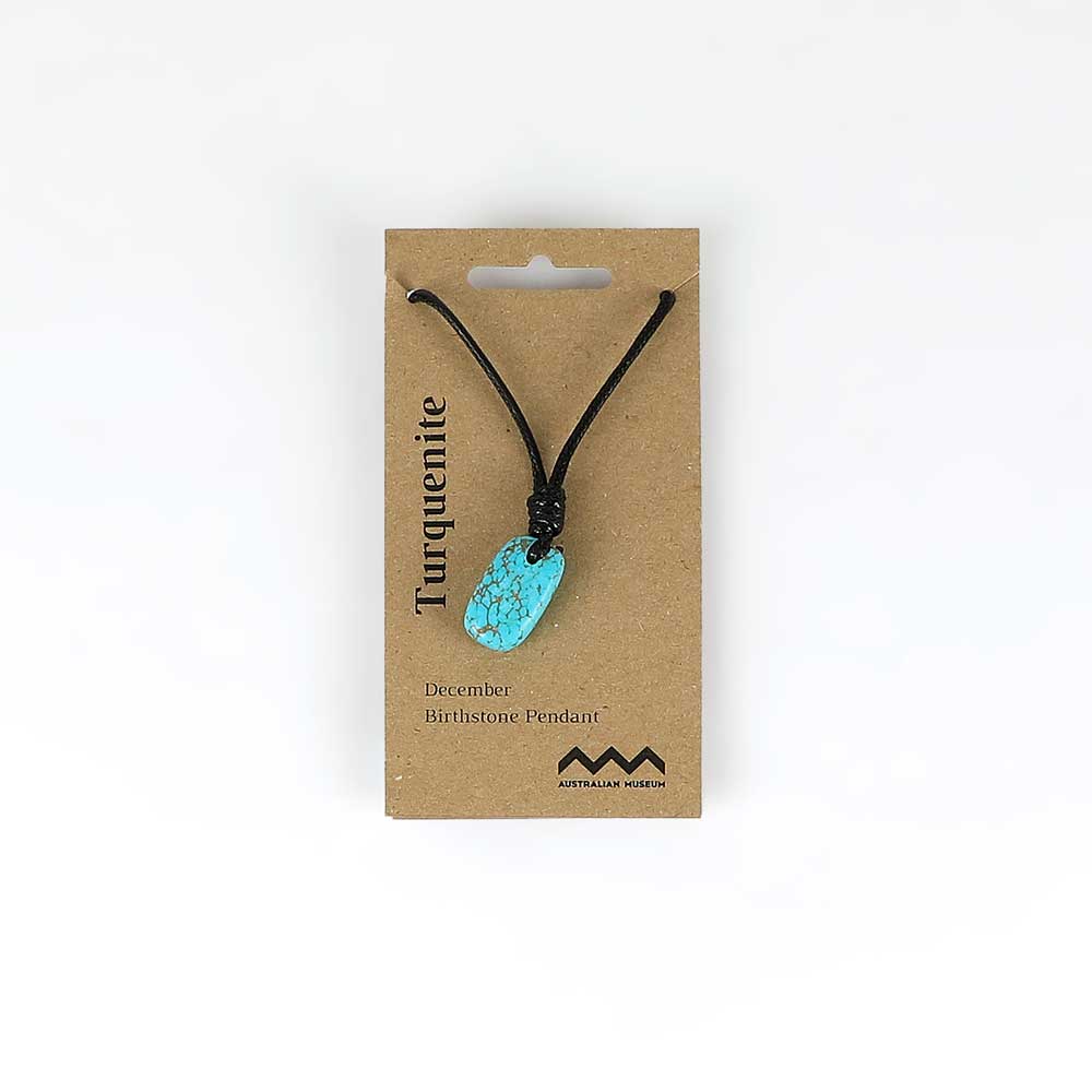 December birthstone pendant on leather and fibre necklace on white background for Australian Museum Shop online