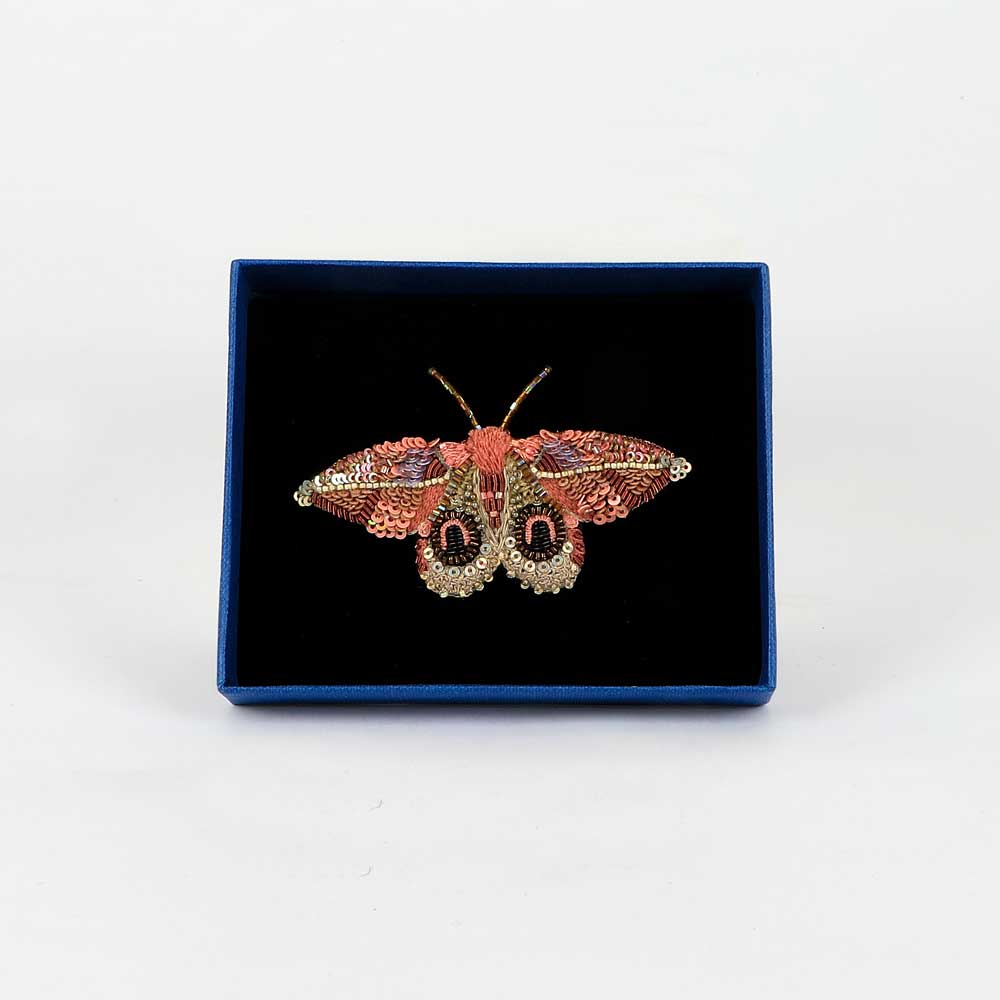 Trovelore Beaded nature brooch hand made in india on white background. Dognins pink bullseye moth