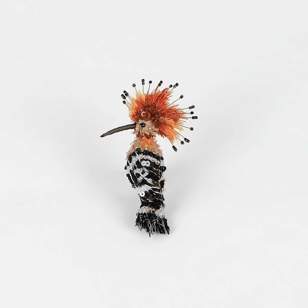 Beaded nature brooch hand made in india on white background. Eurasian hoopoe brooch