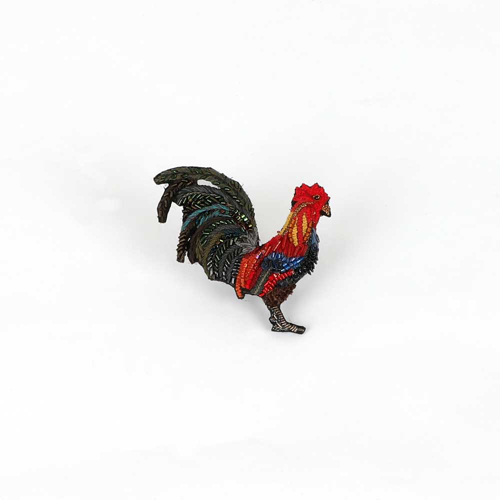 Beaded nature brooch hand made in india on white background. Farm rooster brooch