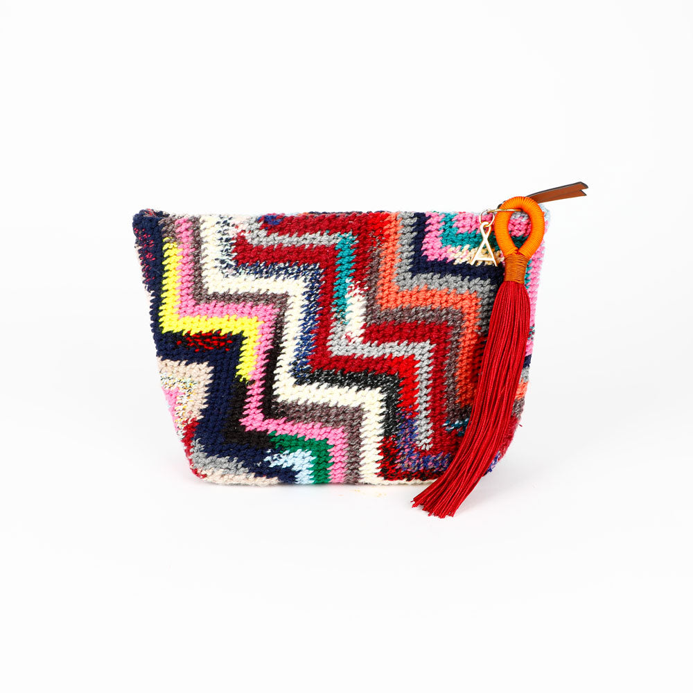 Colorful Florence Steps hand woven Bilum bag with geometric pattern, zip closure and orange and burgundy tassel, on a white background