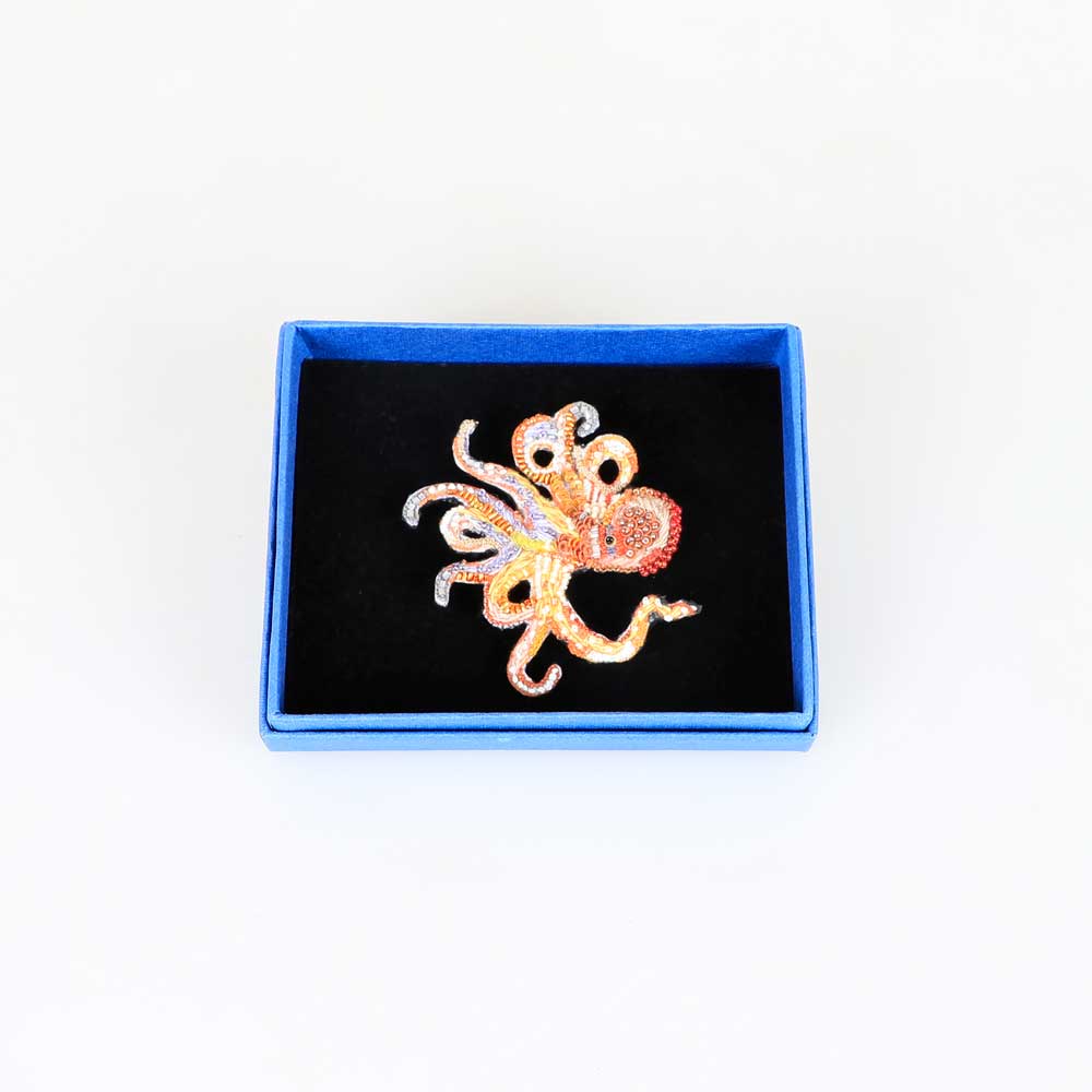 Beaded nature brooch hand made in india on white background. Giant Pacific Octopus