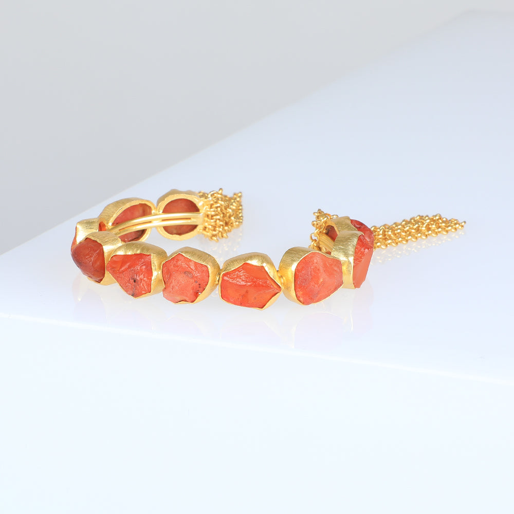 Gold Plated Cuff bracelet with carnelian pieces photographed on white background