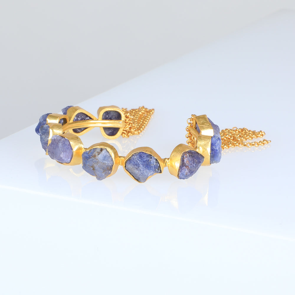 Gold Plated Cuff bracelet with iolite photographed on white background