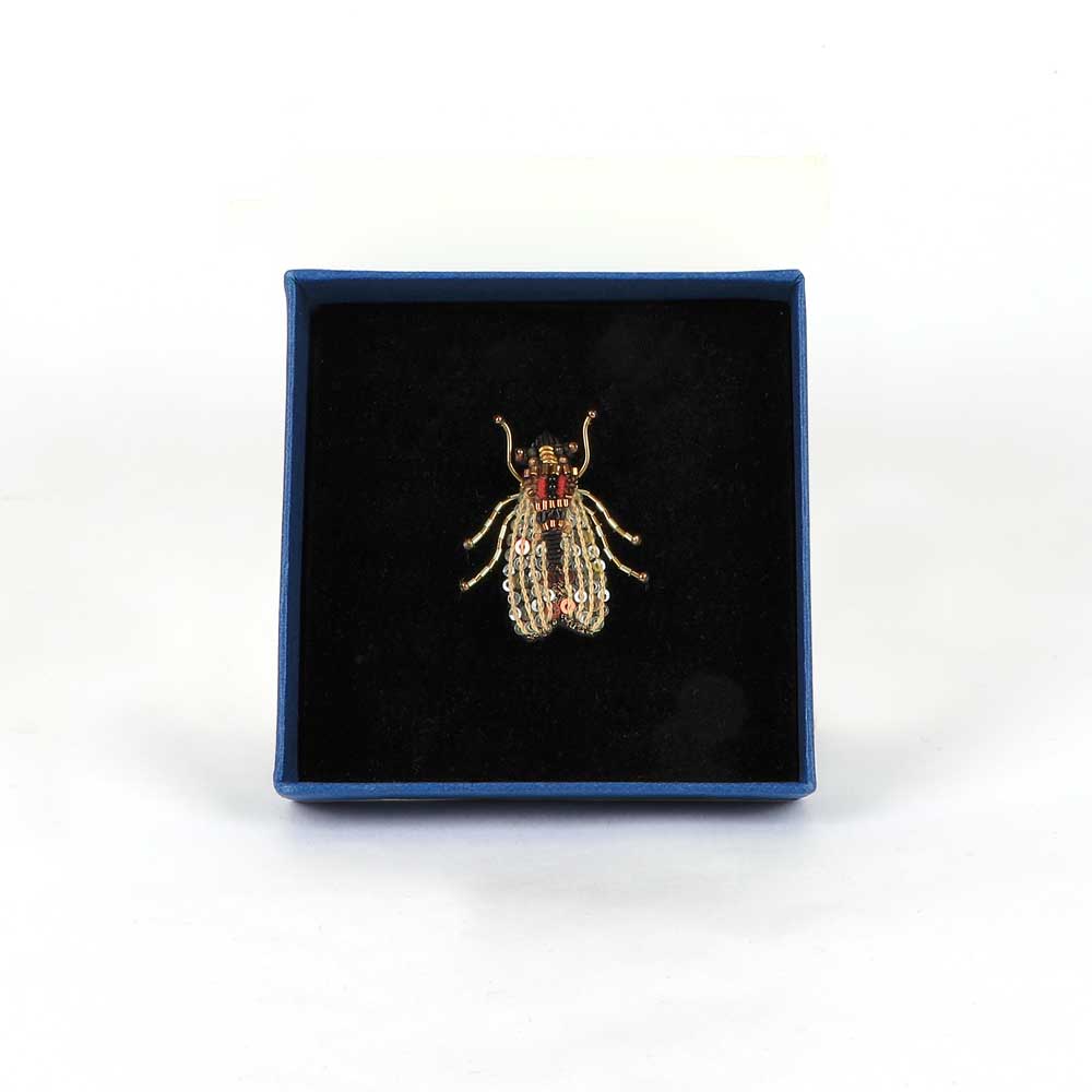 Trovelore Beaded nature brooch hand made in india on white background. Gold fly