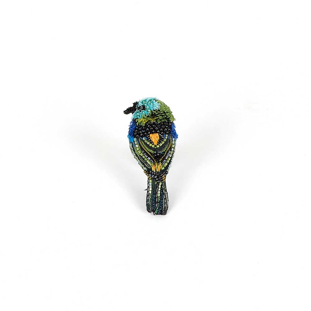 Beaded nature brooch hand made in india on white background. Green headed tanager brooch