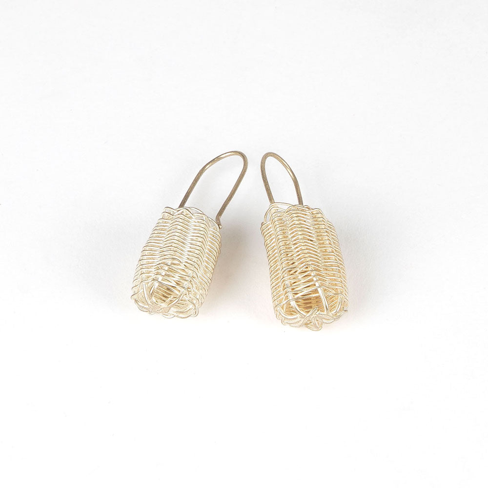 Silver handwoven dilly bag earrings on white background