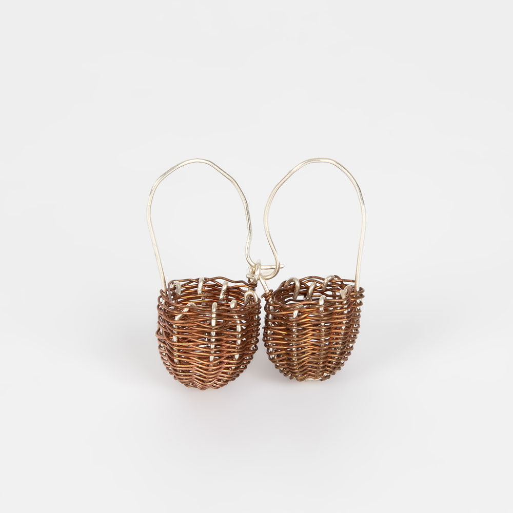 Handwoven copper silver dilly bag earrings on white background