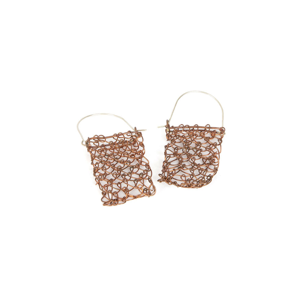 Copper and silver handwoven string bag earrings on a white background