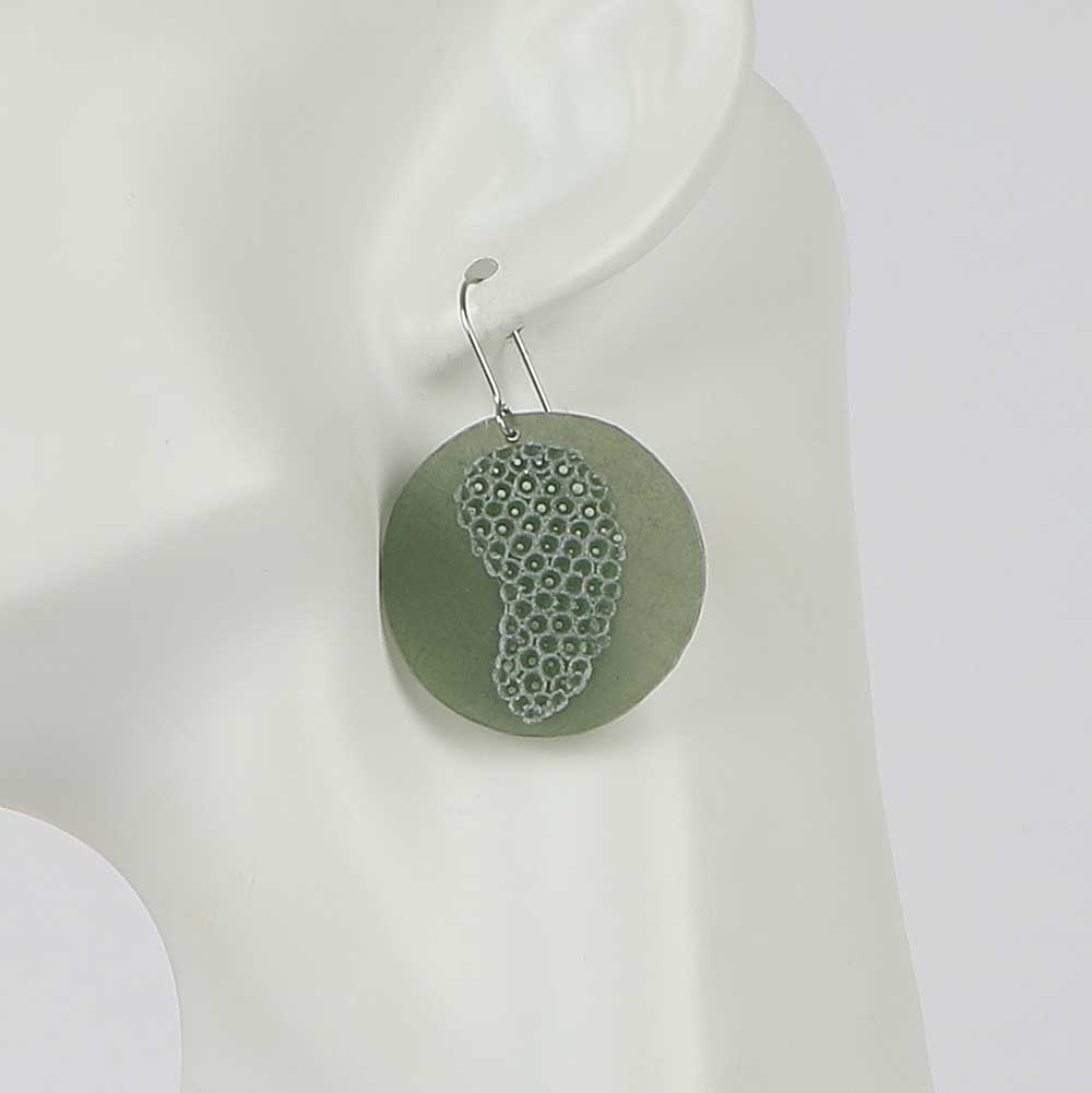 Impronte earrings on mannequin, Sage