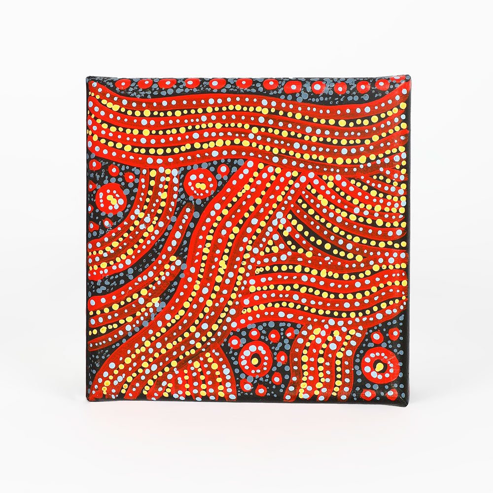 Handpainted canvas from Warlukurlangu Artists Cooperative on white background