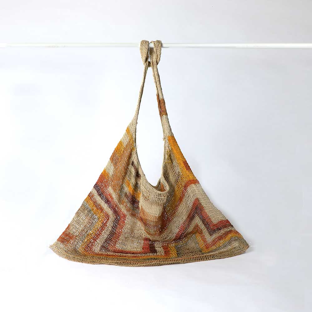 Lina Singu hand woven natural dyed Bilum Bag on white background