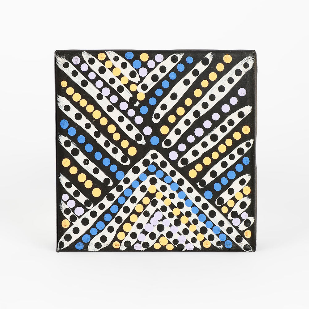 Handpainted canvas from Warlukurlangu Artists Cooperative on white background