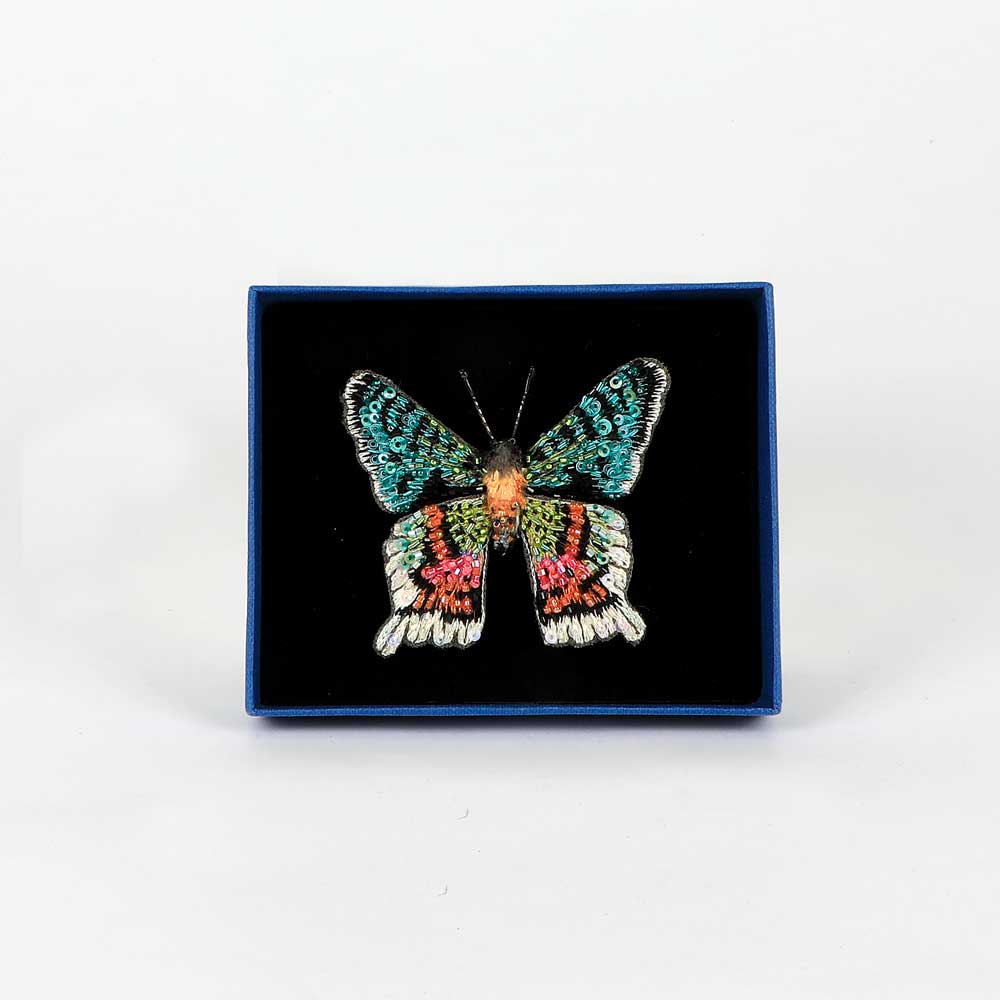 Trovelore Beaded nature brooch hand made in india on white background. Madagascar Sunset Moth