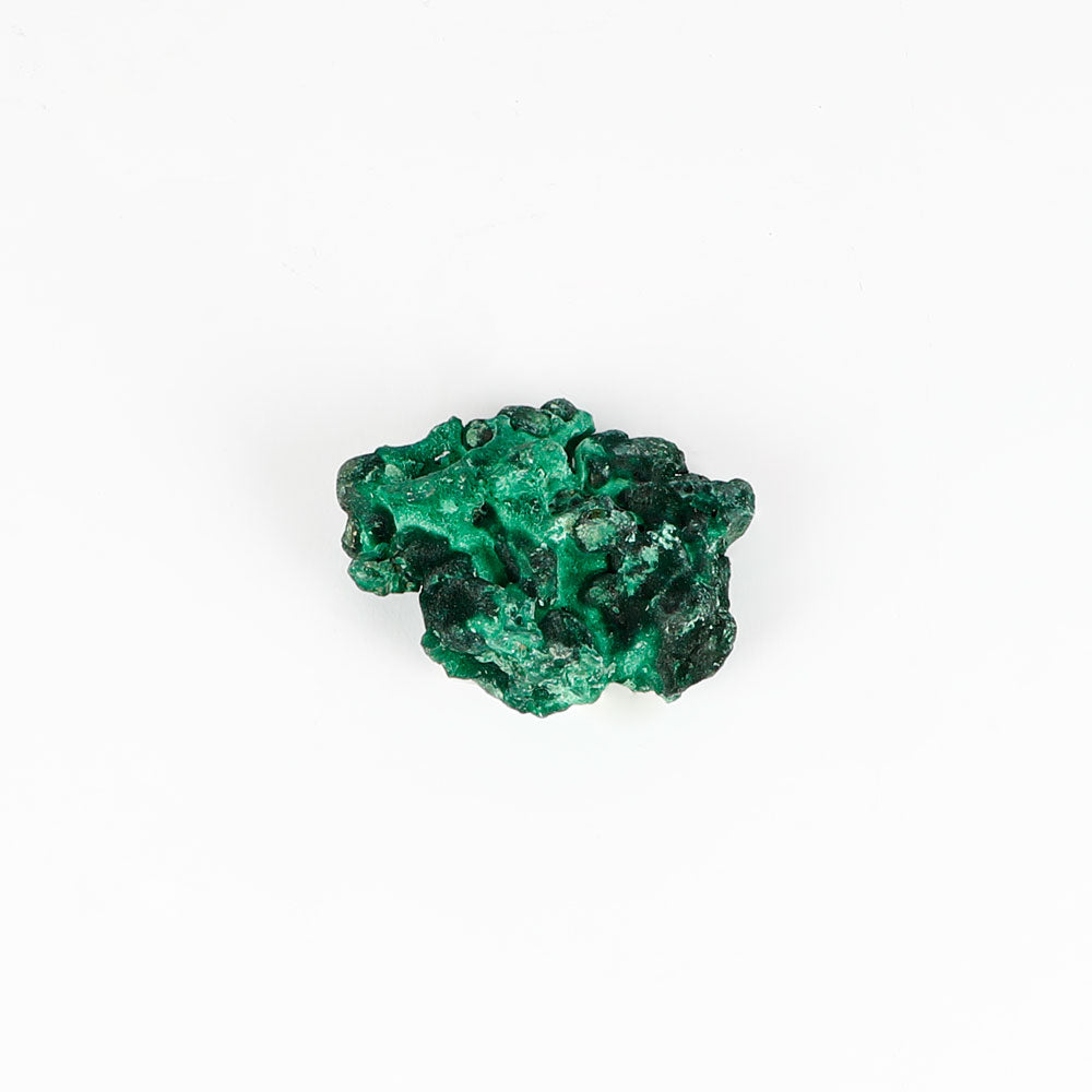 Malachite fibrous crystalline mineral specimen on a white background