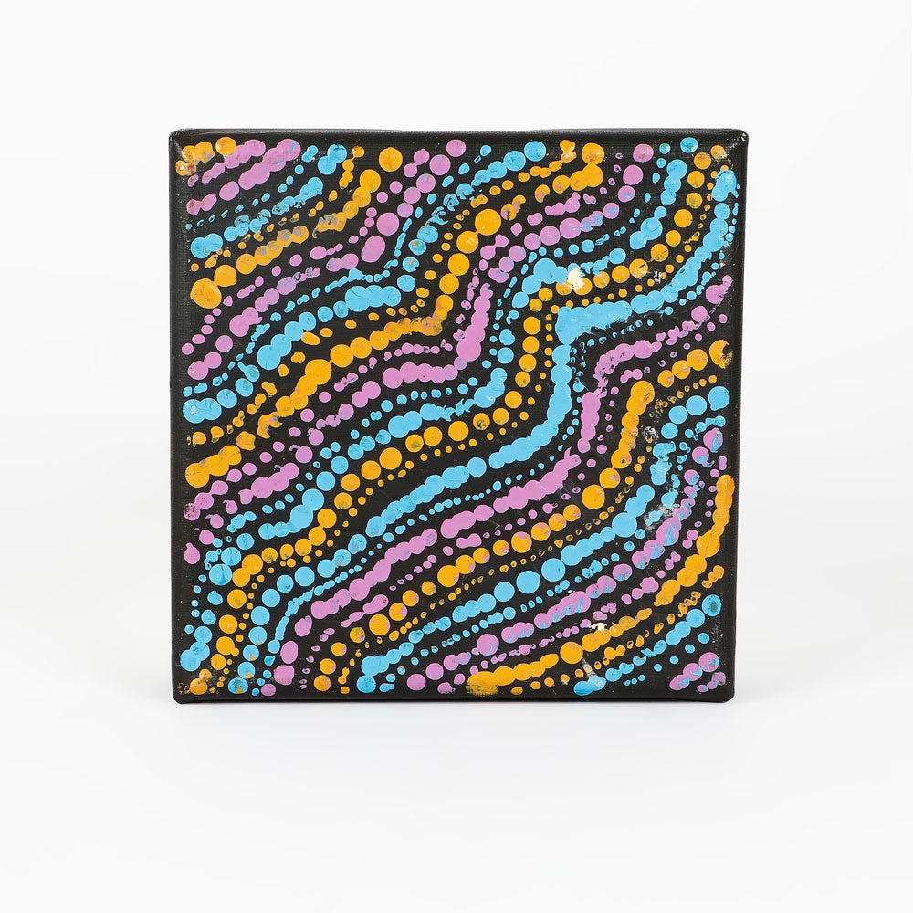 Handpainted canvas from Warlukurlangu Artists Cooperative on white background