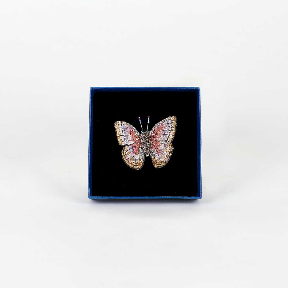 Trovelore Beaded nature brooch hand made in india on white background. Morpho Godarti butterfly