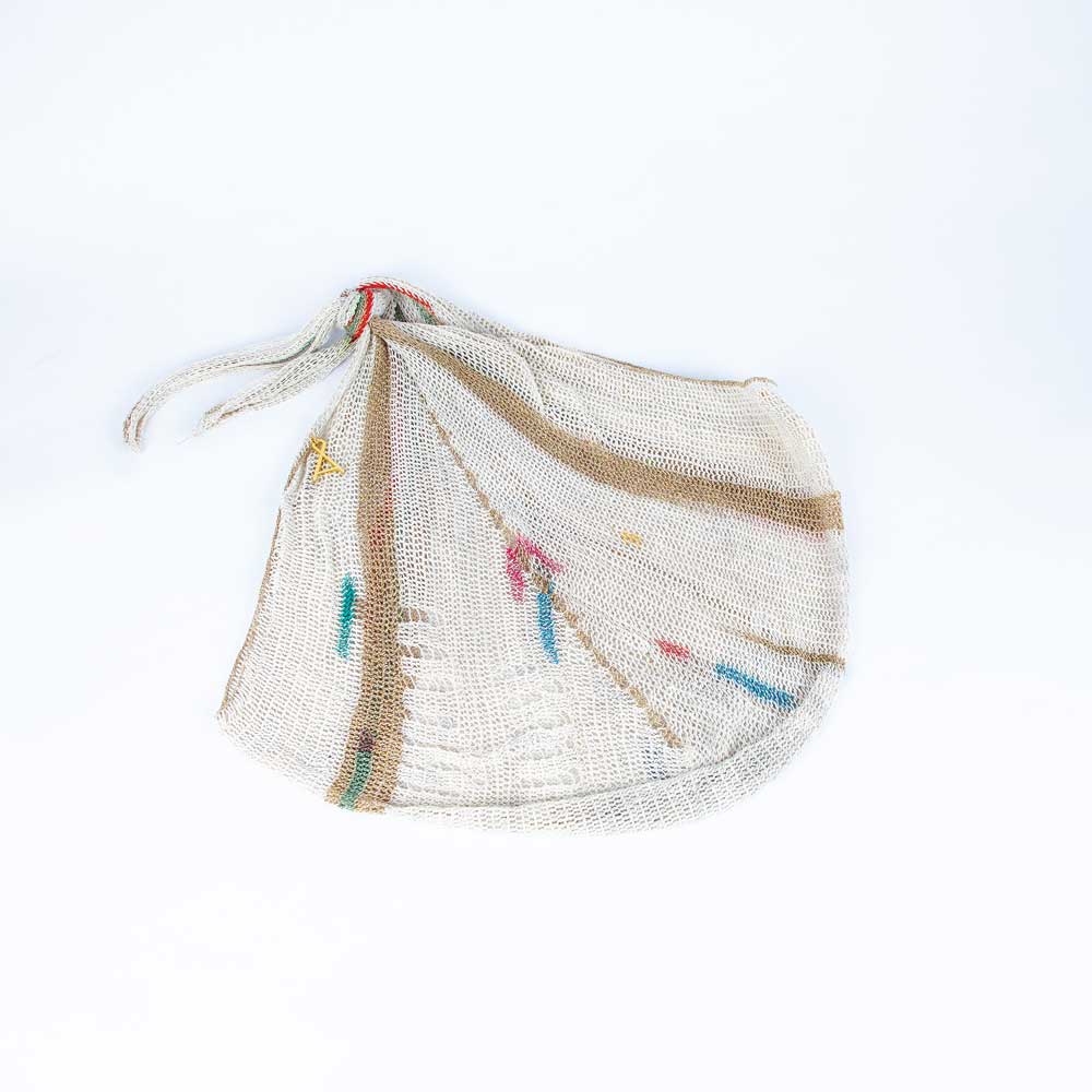 Natural fibre traditional design bilum bag handwoven by Alma Joel. Photographed on white background