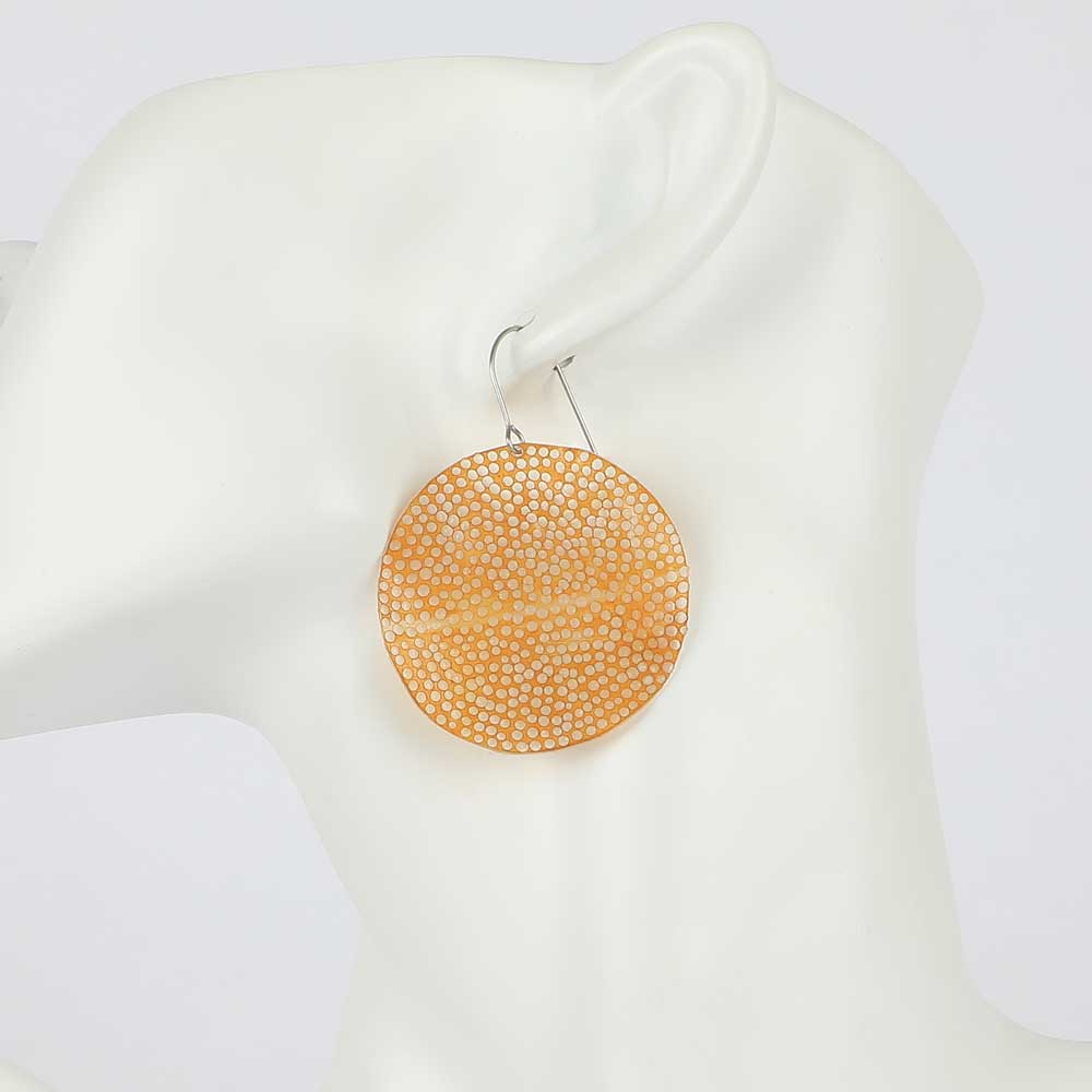 Nuvola upcycled PET disc earrings on mannequin, Mustard