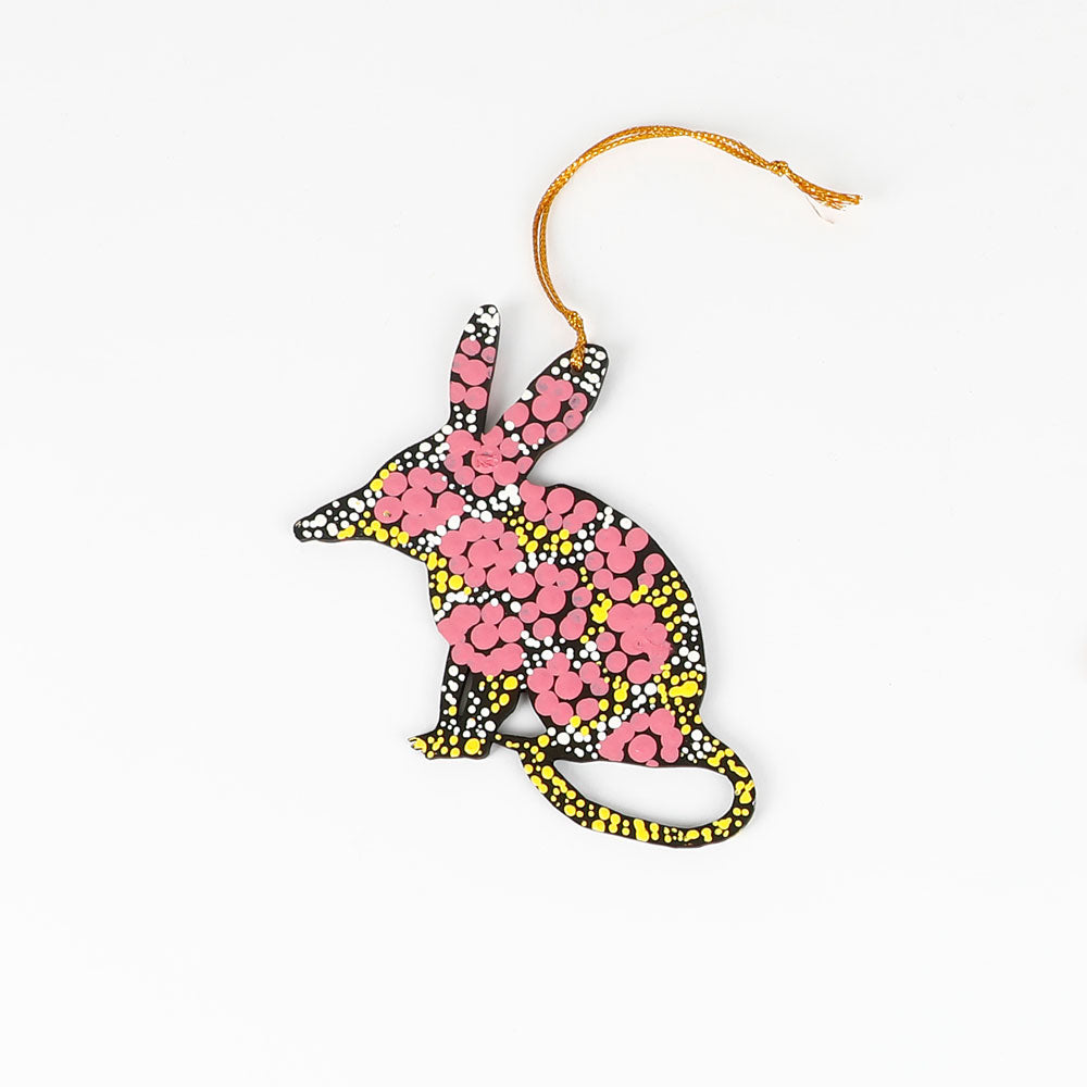 Decorative bilby ornament with pink and yellow pattern  handpainted by Warlukurlangu Artists, on a white background
