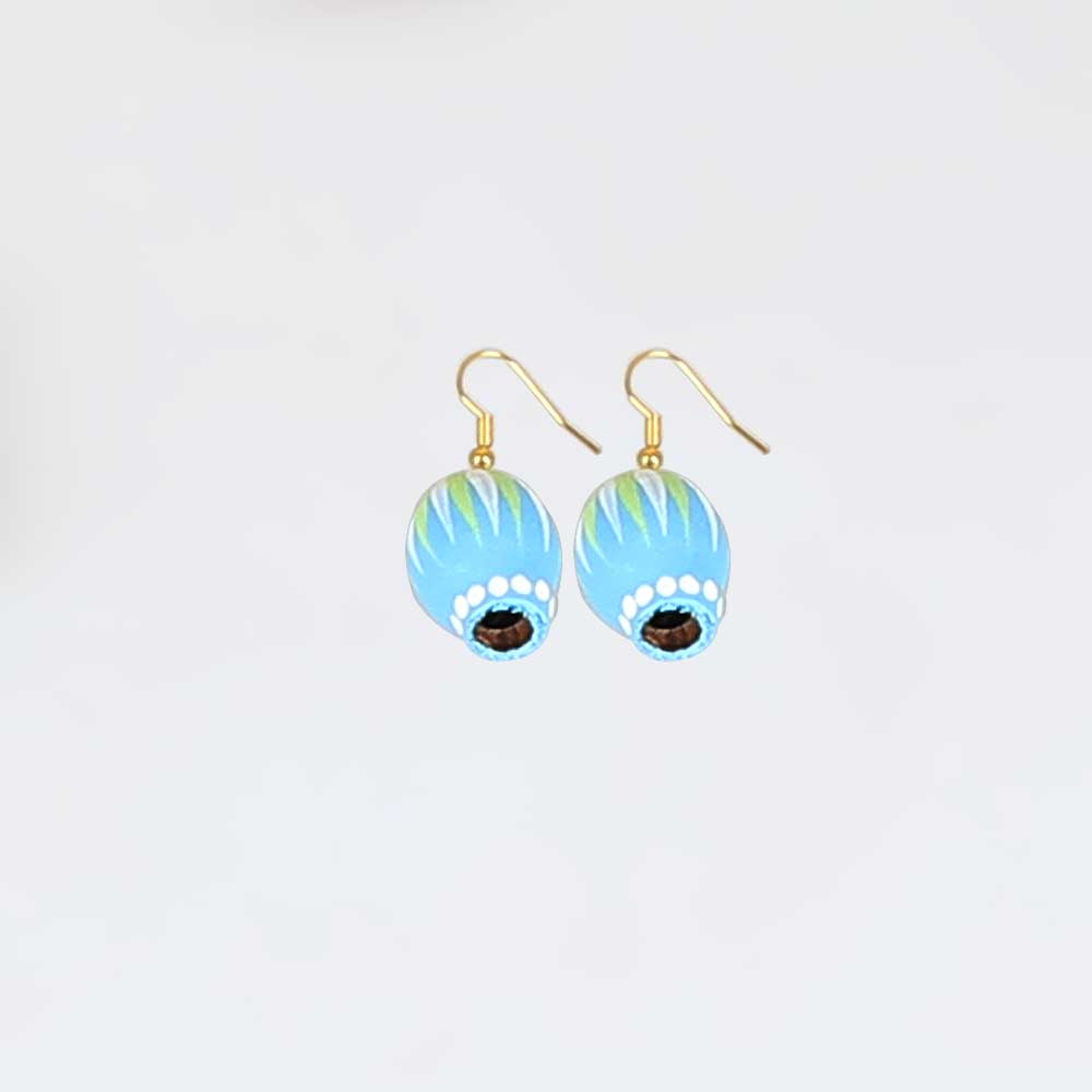 Painted seed earrings on white background