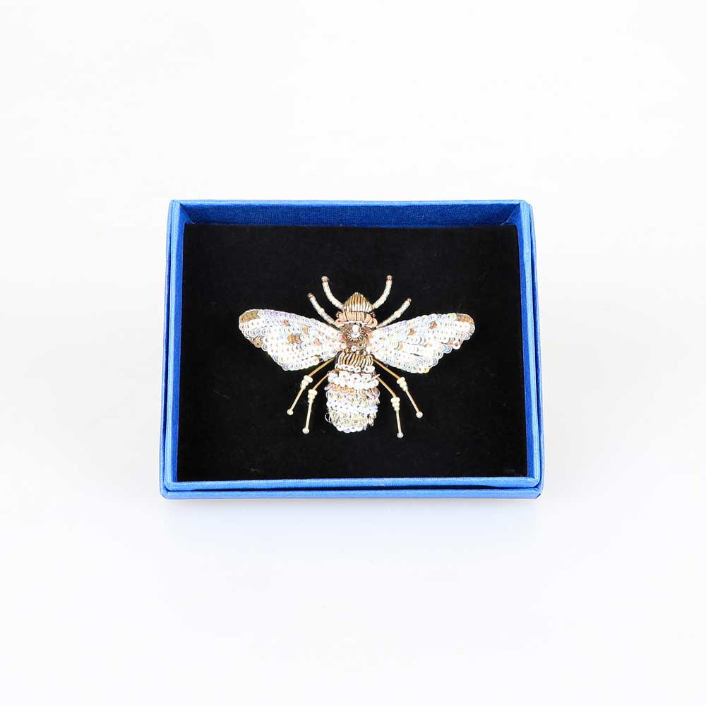 Trovelore Beaded nature brooch hand made in india on white background. Pearl bee brooch