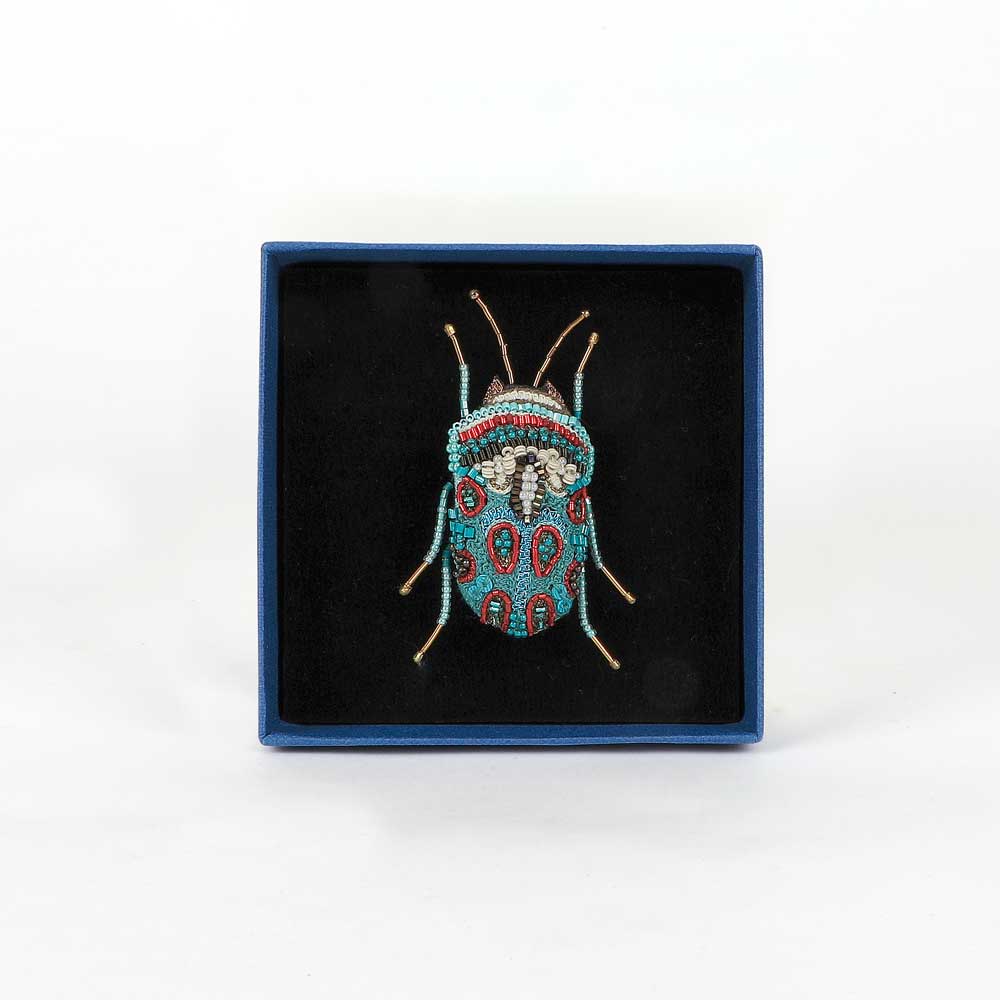 Trovelore Beaded nature brooch hand made in india on white background. Picasso Bug