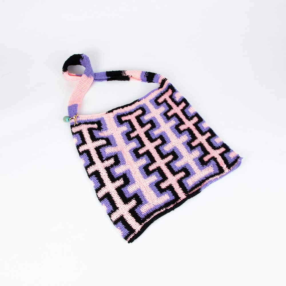 Pink and lilac handwoven bilum bag by Rosa Hofman on white background