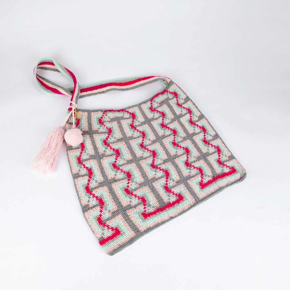 PInk blue and cherry handwoven bilum bag by Nancy Fike on white background