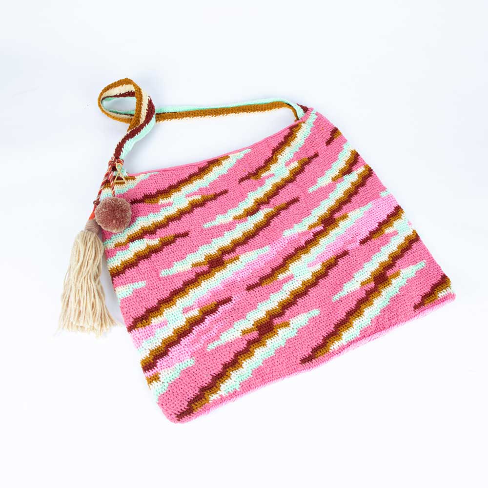 Pink, cream and tan handwoven bilum bag by Salome Park on white background
