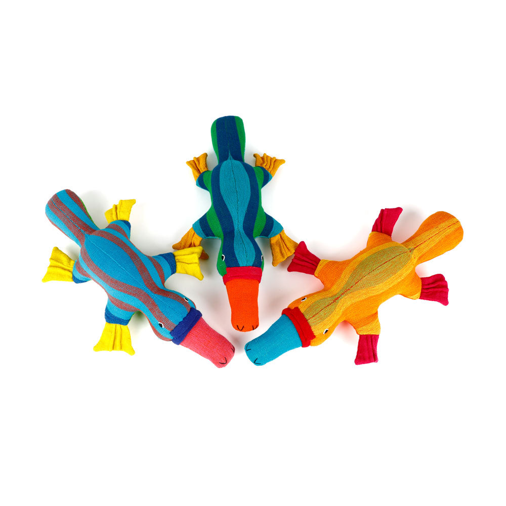 Colorful platypus hand made from handwoven fabric by Barefoot Toys on a white background