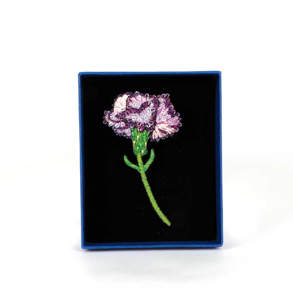 Purple carnation Trovelore Beaded embroidered floral brooch on white background