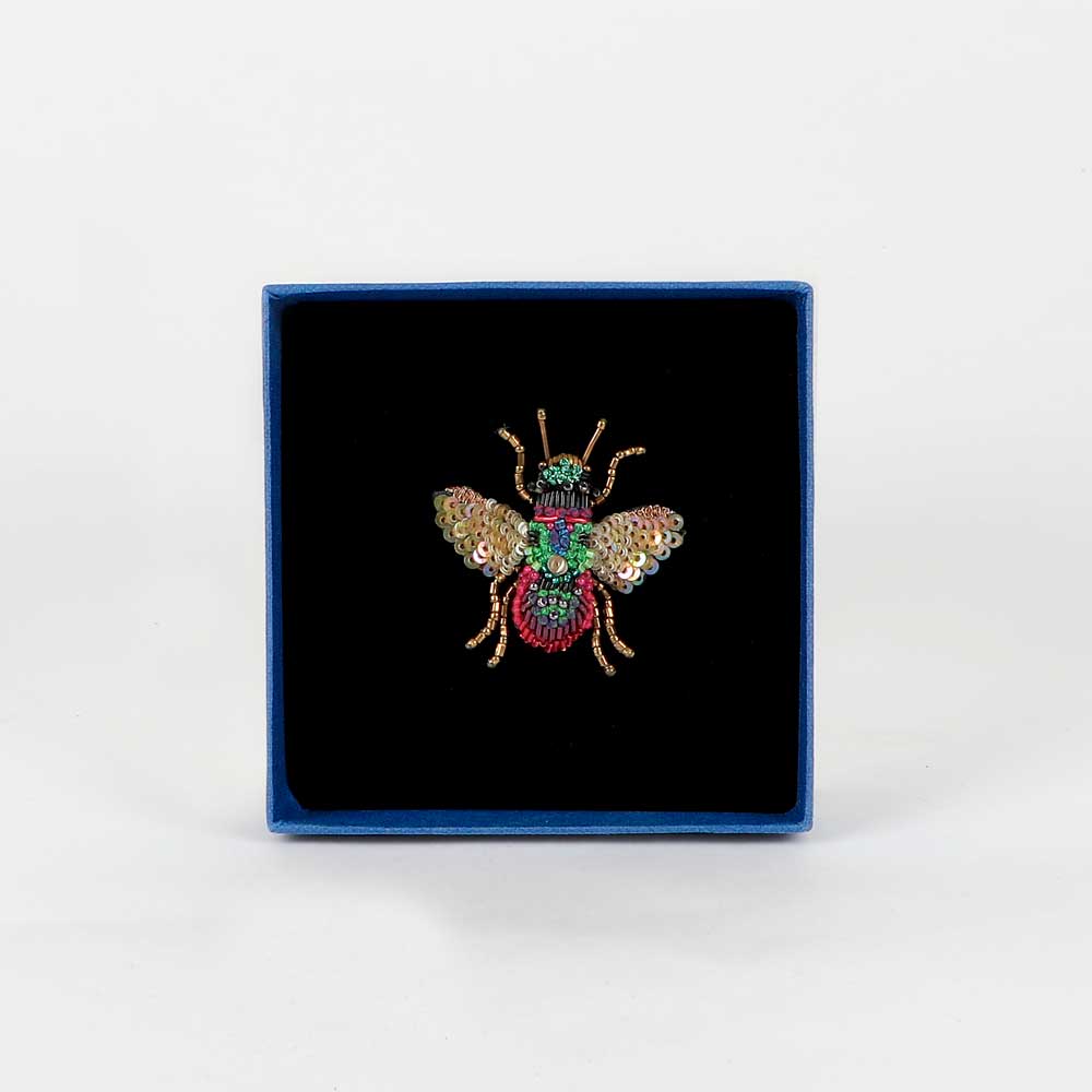 Trovelore Beaded nature brooch hand made in india on white background. Rainbow bee