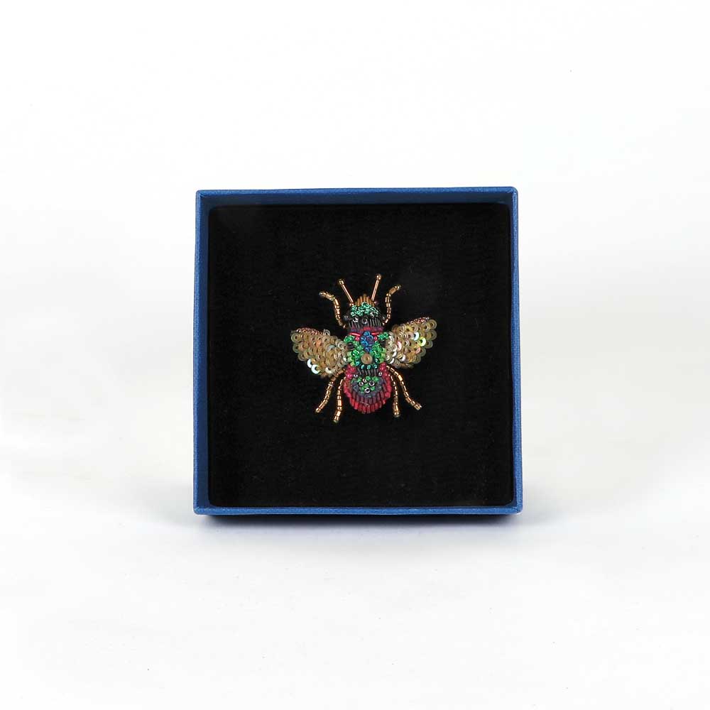 Trovelore Beaded nature brooch hand made in india on white background. Rainbow bee