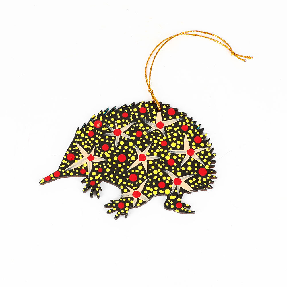 Decorative echidna ornament handpainted by Warlukurlangu Artists, on a white background