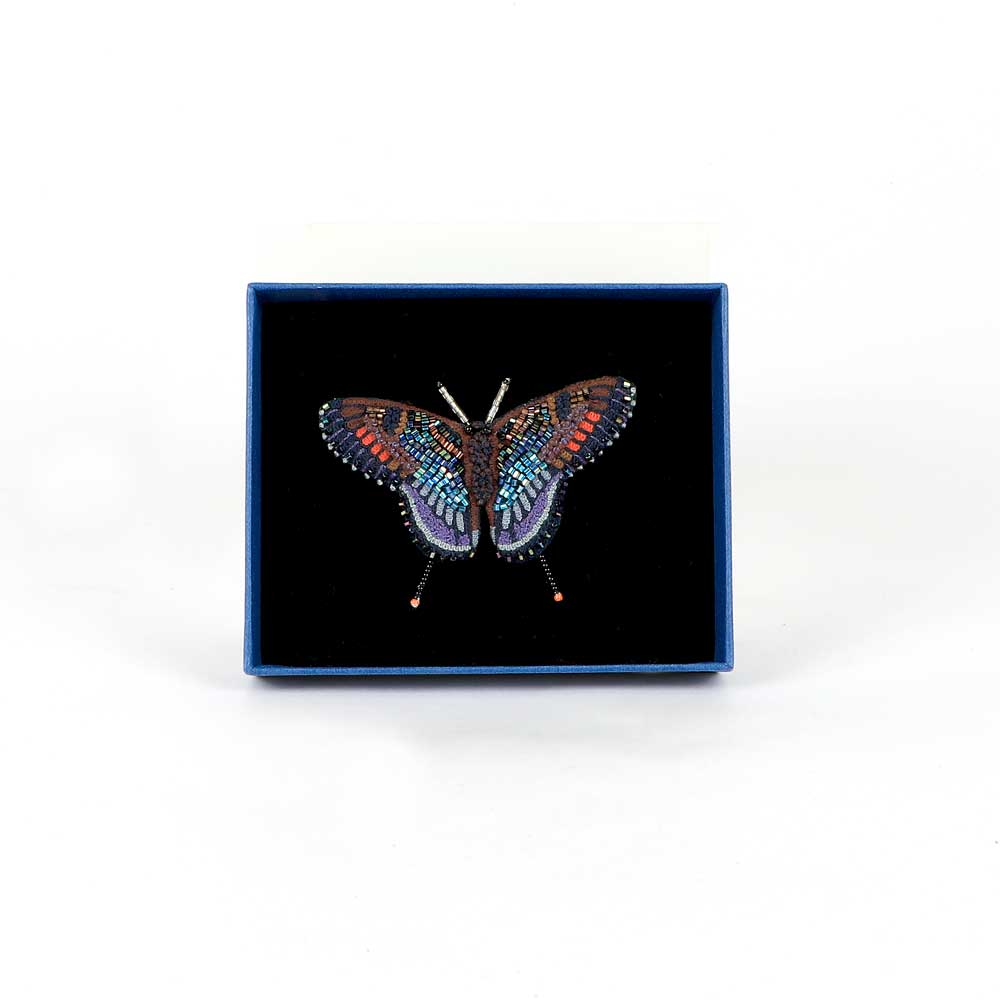 Trovelore Beaded nature brooch hand made in india on white background. Red spotted purple butterfly