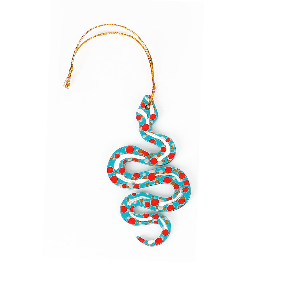Decorative snake ornament handpainted by Warlukurlangu Artists, on a white background