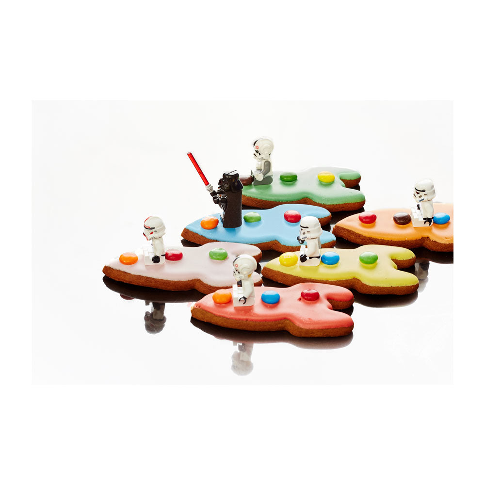 Colourful biccies with Star wars minifig drivers on a white background