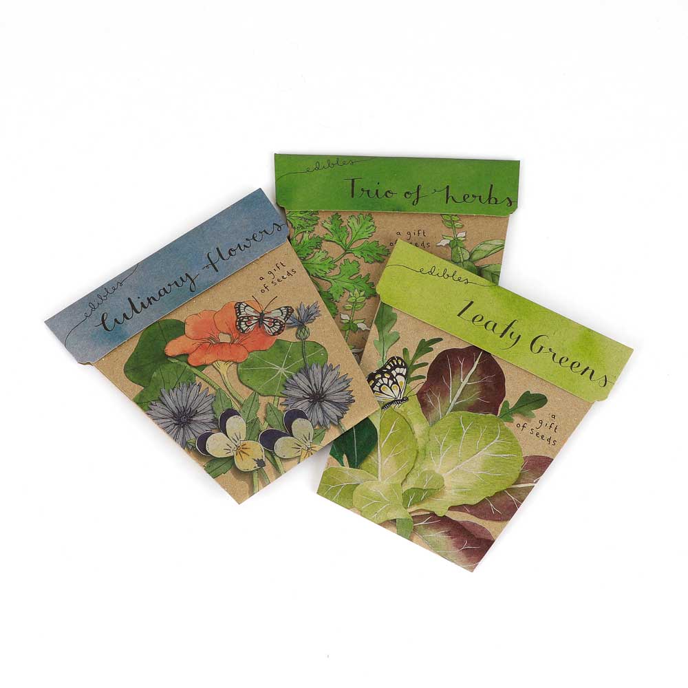 Gift of seeds edibles bundle: culinary flowers, trio of herbs, leafy greens on white background