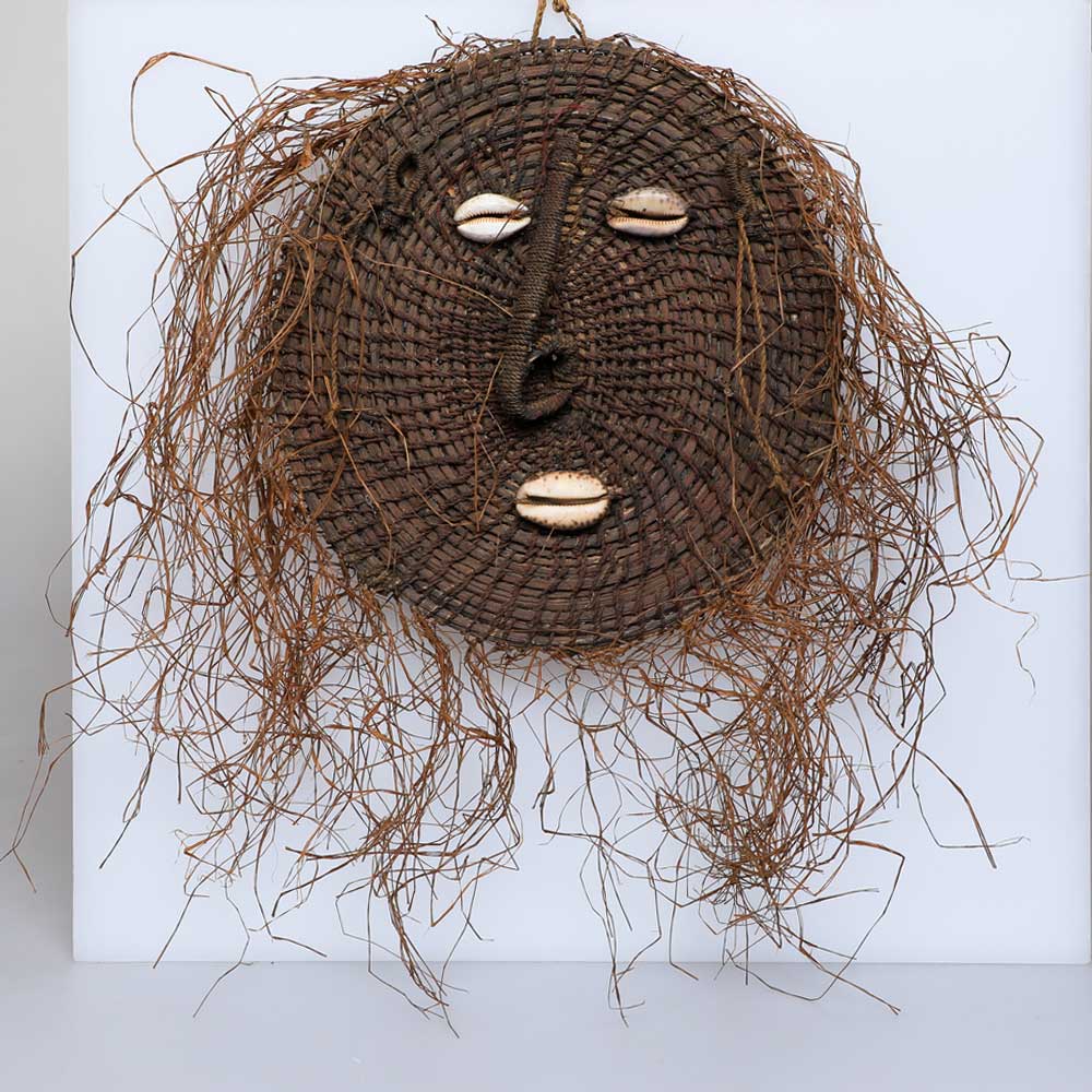 Sepik river mask, handwoven. Grass and shells. photographed against white Australian Museum Shop online