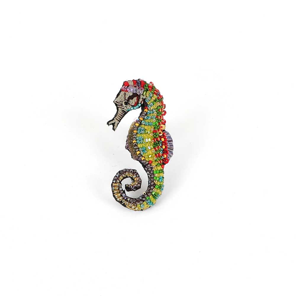 Beaded nature brooch hand made in india on white background.Spotted seahorse brooch