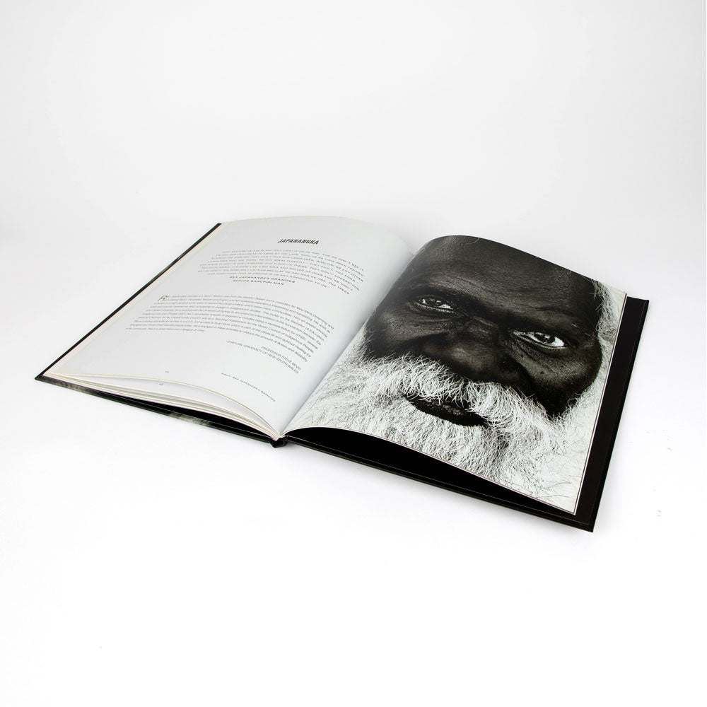 Open book: Unfinished Business with black and white portrait on a white background