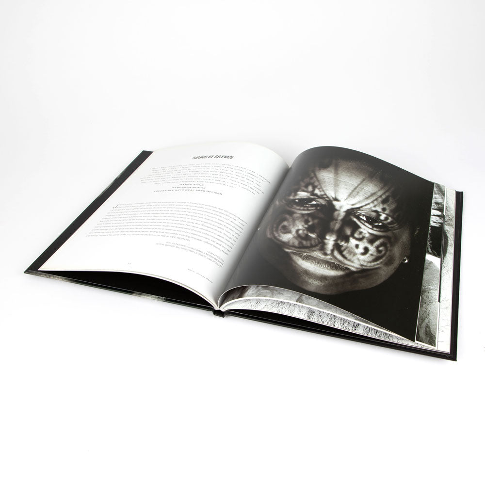 Open book: Unfinished Business with black and white portrait on a white background